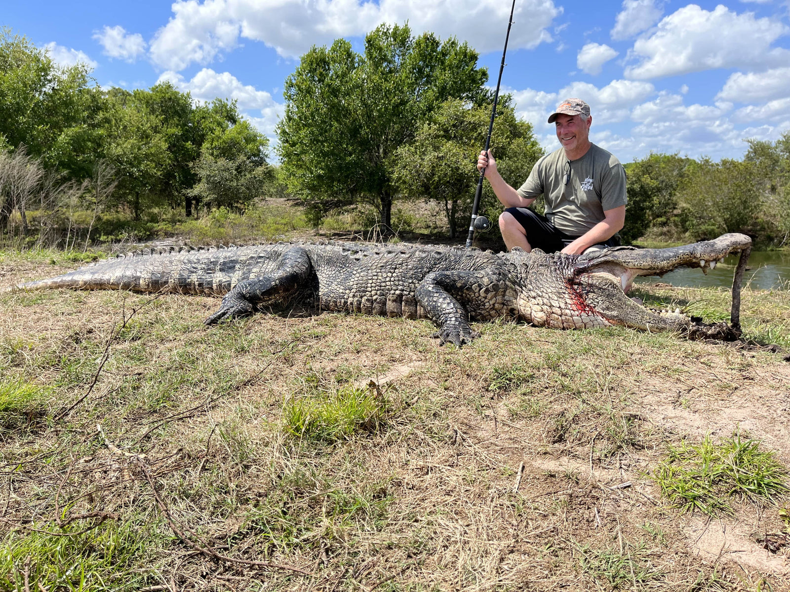 person sitting beside an alligator 